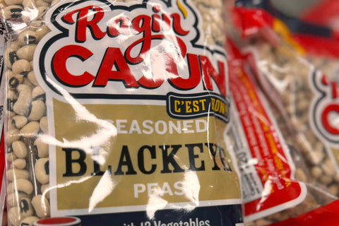 Packaged black-eyed peas with 'Ragin' Cajun' branding on a blurred background