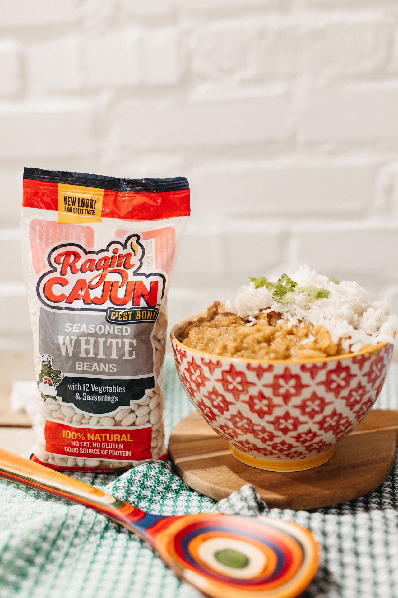 Ragin' Cajun seasoned white beans beside a bowl of beans and rice
