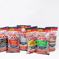 Product photograph featuring multiple Ragin' Cajun seasoned bean and soup packages including Black, Red, Pinto, and 10 Bean Soup, each with a red and white design, a "NEW LOOK! SAME GREAT TASTE" banner, and a chef alligator logo on a white studio background