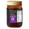 Product photograph of an Acadian Kitchens food jar featuring a dark amber glass body, gold ribbed lid, and a purple label displaying '100% Natural' ingredients, detailed nutrition facts, and a QR code from Lafayette Louisiana