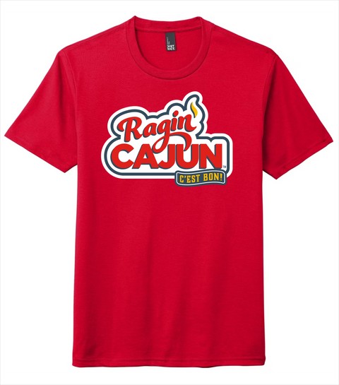 Red t-shirt by District featuring a Ragin' Cajun C'est Bon! logo with bold red script and block lettering, a small yellow flame detail, and the phrase C'est Bon! in a yellow and black banner