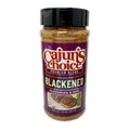 Product photograph of a Cajun's Choice Premium Blend Blackened Seasoning & Rub bottle featuring a vibrant purple label with bold red and white text, and an appetizing illustration of blackened fish fillets served with green asparagus and a yellow lemon wedge