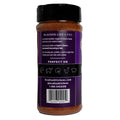 Photograph of a Cajun's Choice Blackened Seasoning & Rub bottle with a dark purple label displaying "BLACKEN LIKE A PRO" text, cooking instructions for seafood and meats, and line art icons representing shrimp fish crab chicken and pork, filled with reddish-brown seasoning on a white background