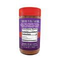 A clear seasoning bottle with a bright red cap and purple label featuring Acadian Kitchens LLC Premium Blend, detailing ingredients like pure ground peppers and fine chili powder, with zero calories displayed in the nutrition facts