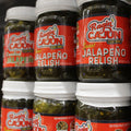 Photography of Ragin' Cajun Sweet Jalapeño Relish jars displayed on a store shelf, featuring vibrant red labels with 'C'est Bon' text, the green relish visible within, and white jar lids