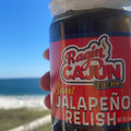 Jar of Ragin Cajun Sweet Jalapeño Relish held against a beach background