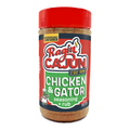 Ragin' Cajun Chicken & Gator Seasoning + Rub bottle displays a bright red lid, a vibrant red and green label with the 'C'est Bon!' slogan, and a playful cartoon gator chef holding a spoon, all isolated on a white background