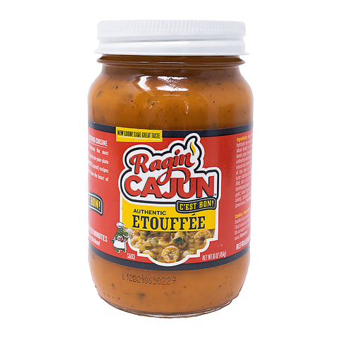 Photograph of a clear glass jar of Ragin' Cajun Authentic Etouffée Sauce with an orange-brown color, featuring a bold red label with a cartoon alligator chef and flame graphic, and yellow banners stating AUTHENTIC ETOUFFÉE and NEW LOOK! SAME GREAT TASTE