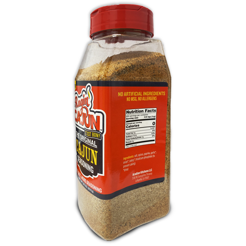 A clear plastic bottle of Raquin's The Original Cajun Seasoning from Acadian Kitchens LLC Lafayette LA featuring a vibrant red flip-top cap a distinctive red and white label and the prominent claim of "No MSG No Allergens"