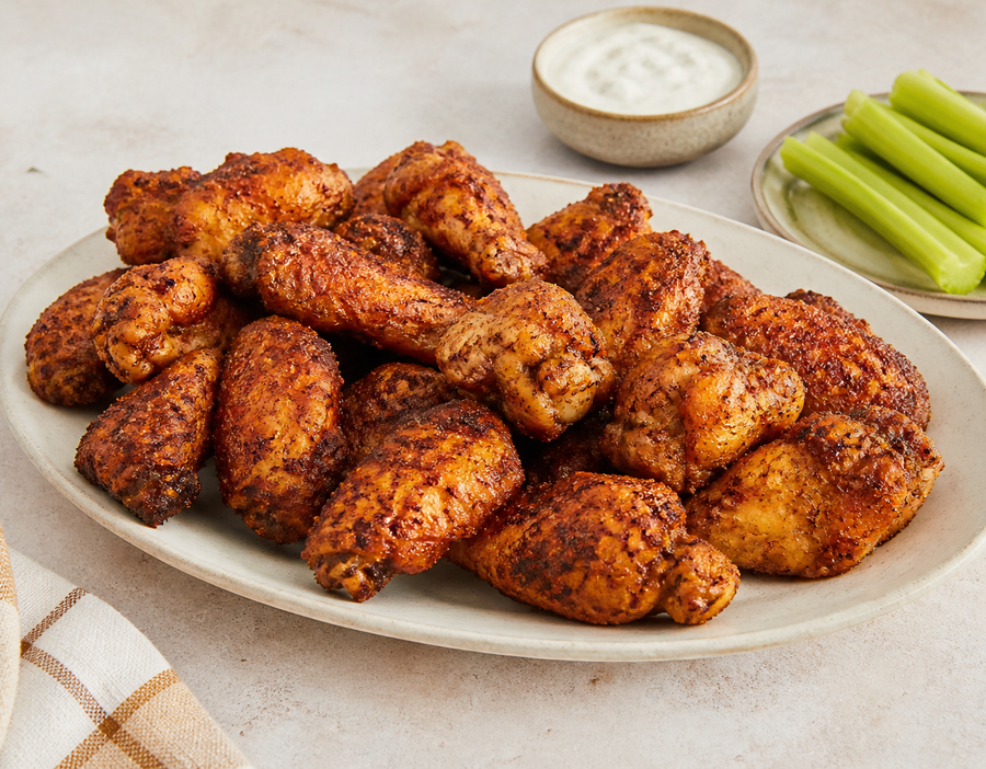 Crisp Cajun chicken wings with celery and a creamy dipping sauce
