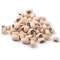 Heap of dry off-white black-eyed peas, each with a distinctive black oval eye, on a crisp white background
