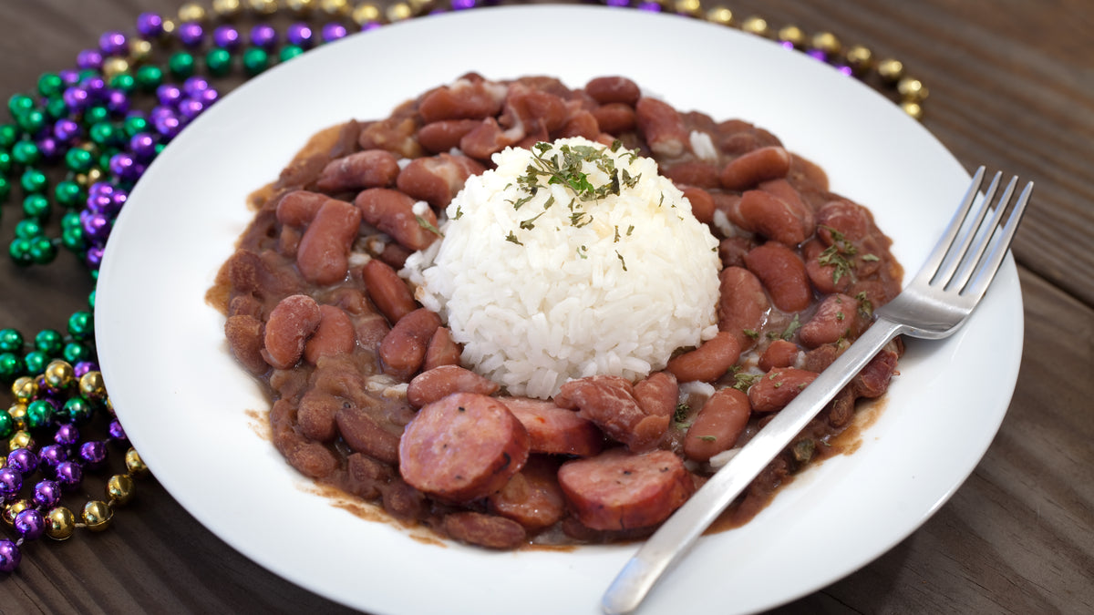 Plate of red beans and rice with sausage and herbs
