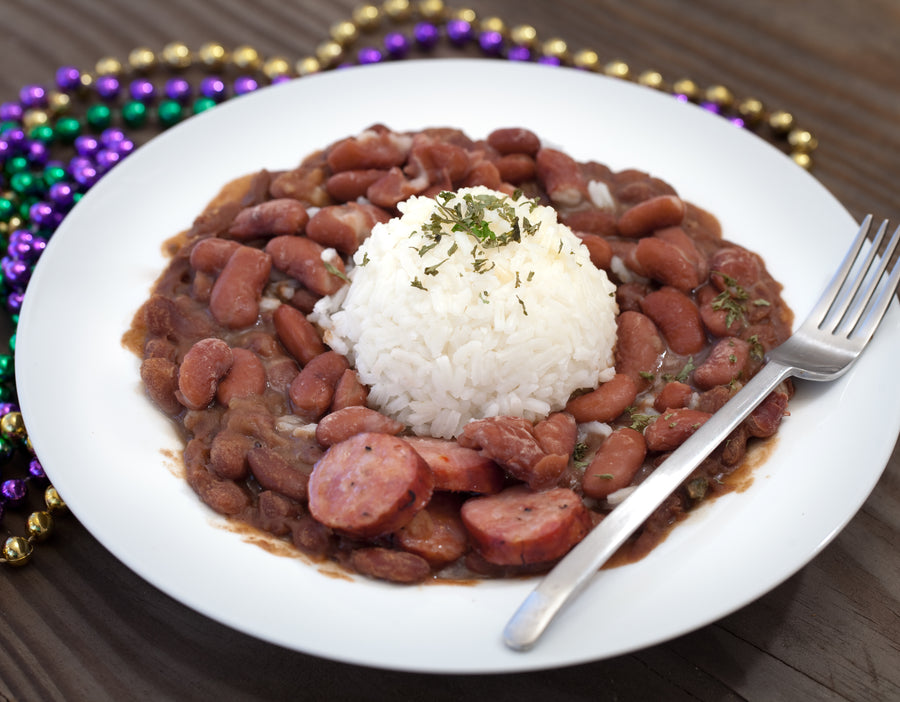 Plate of red beans and rice with sausage and herbs